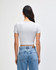 A grey crop fitted T-shirt is displayed on a model, showing a back view paired with blue jeans.
