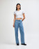 A fitted grey crop t-shirt paired with high-waisted blue jeans. The model stands confidently against a neutral background.