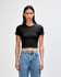 A black cropped fitted t-shirt displayed on a model with straight hair and blue jeans. The shirt features a logo.
