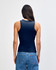 A fitted tank top in navy blue, viewed from the back, paired with high-waisted jeans. The top features a logo.