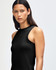 A fitted women's tank top in black, featuring a sleeveless design and a round neckline. It includes a small logo.