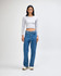 A fitted grey long sleeve crop top paired with loose blue jeans, modelled by a standing woman.
