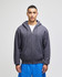 A grey full-zip hooded sweatshirt worn by a model, paired with blue shorts. The sweatshirt features a logo.