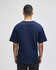 A navy blue Champion Adult Heritage Jersey T-Shirt viewed from the back. It features short sleeves and a relaxed fit.