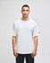 A grey Champion Adult Heritage Jersey T-Shirt displayed on a male model against a plain background.