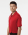 A model wearing a red Men's Pro-Lock Performance Polo with a collar and short sleeves, featuring a logo.
