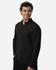 A black men's stretch fleece 1/4 zip top, featuring a zip neck and a relaxed fit, modelled by a smiling man.