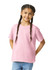 A youth softstyle short sleeve t-shirt in pink, worn by a girl with braided hair, smiling at the camera.