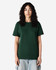 A unisex heavyweight cotton T-shirt in a dark green colour, displayed on a model with curly hair.