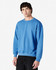A blue crewneck sweatshirt displayed on a model, featuring long sleeves and a relaxed fit. It has a logo.