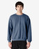 A crewneck sweatshirt in a blue hue, featuring long sleeves and a relaxed fit. It includes a logo on the garment.
