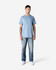 A light blue Gildan Ultra Cotton adult t-shirt on a model, paired with faded jeans and white shoes.