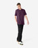 A unisex short sleeve T-shirt in a deep purple colour, paired with black cargo pants, featuring a logo.
