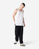A model wearing a white unisex fine jersey tank top paired with dark cargo pants and sneakers.