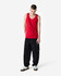 A red unisex fine jersey tank is worn by a model, paired with black cargo trousers and white sneakers.