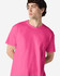 A pink Gildan Heavy Cotton Adult T-Shirt on a model, featuring a plain design and a brand logo.