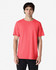 A model wearing a vibrant coral Gildan Heavy Cotton Adult T-Shirt with a relaxed fit.