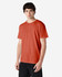 A man wearing a Gildan Heavy Cotton adult T-shirt in a vibrant orange colour, featuring a logo.