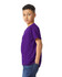 A young model wearing a purple Gildan Heavy Cotton Youth T-Shirt, posing sideways with hands in pockets.