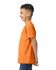 An orange Gildan Heavy Cotton Youth T-Shirt is displayed on a child from the side, showcasing its fit and style.