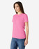 A pink Gildan Heavy Cotton ladies' T-shirt displayed on a model, showcasing a round neckline and short sleeves.