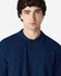 A man wearing a navy blue Gildan Softstyle Adult Double Pique Polo with a collar and buttons.