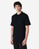 A model wearing a black Gildan Softstyle Adult Double Pique Polo, featuring a classic polo collar and short sleeves.