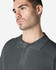 A model wearing a dark grey Gildan Softstyle Adult Double Pique Polo, featuring a classic collar and three-button placket.