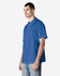 A man models a royal blue Gildan Softstyle Adult Double Pique Polo, featuring a logo on the left side.
