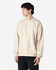 A beige Gildan Softstyle adult sweatshirt is displayed on a model, with a plain design and a visible logo.