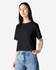A black women's fine jersey boxy T-shirt displayed on a model, featuring a simple design and relaxed fit.