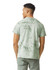 A heavyweight T-shirt in a light green colour with a marbled pattern, featuring a logo on the back.