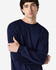 A model wearing a navy long sleeve T-shirt with a relaxed fit and a logo on the sleeve.