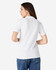 A white ladies' polo shirt with short sleeves, featuring a logo on the back, paired with blue jeans.