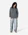 A grey unisex crewneck sweatshirt worn with light blue cargo pants and black shoes. The sweatshirt has a logo.