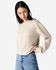 A cream women's crewneck sweatshirt with a relaxed fit, featuring long sleeves and a simple design.