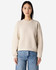 A cream women's crewneck sweatshirt with a casual fit, modelled by a woman. Featuring long sleeves and a simple design.