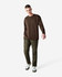 A model wearing a brown long-sleeve shirt with a pocket and green cargo pants, paired with sneakers.