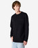 A black long-sleeve t-shirt featuring a pocket, modelled by a person with curly hair. The shirt has a logo.
