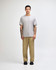A grey American Apparel Super Heavyweight T-Shirt displayed on a model, paired with light blue jeans and sneakers.