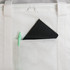 A black notebook and green pen are visible in a front pocket of a white cooler bag. The bag features a zippered closure.