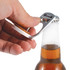 A drink bottle opener in silver, designed as a phone stand, being used to open a glass bottle.