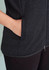 A black vest featuring a zip front and side pockets, with a smooth fabric texture. It has a branding logo.