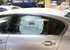 A car window featuring a round sunshade with a graphic of a car and the text "SPINTERN." The shade is white with black details.