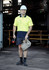 A man wearing a high-vis yellow and navy polo shirt, shorts, and a hard hat, holding work gear in a warehouse setting.