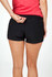 Black women's FLEX shorts featuring a 4-way stretch design, with an elastic waistband and a small pocket detail.