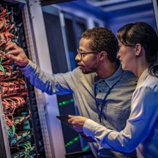 people examining a server rack