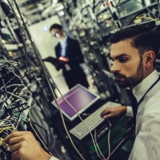 man examining a server rack
