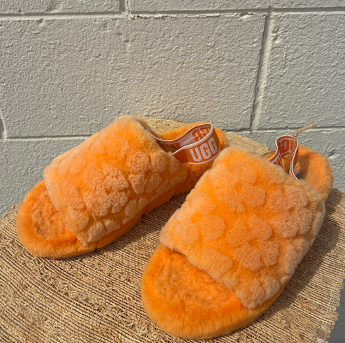 A plush, soft orange upper makes these UGG slides the ultimate comfort shoe. Whether lounging at home or running errands, this cozy statement piece is the perfect addition to your casual rotation!