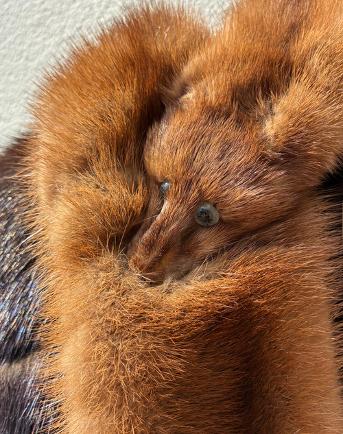 A classic mink stole featuring the traditional head-and-tail styling, complete with three intact mink heads for an authentic vintage silhouette. A striking collector's piece that captures old Hollywood glamour. Perfect for layering!